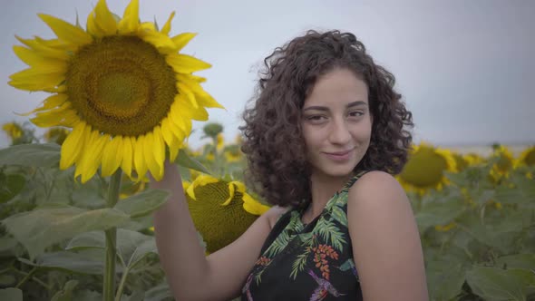 Portrait of Cute Fun Curly Playful Sensual Woman Looking at the Camera Smiling