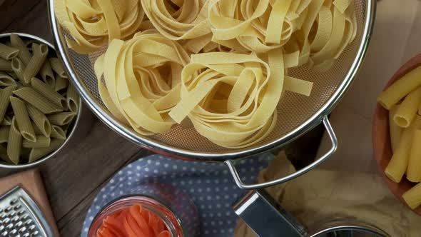 Dry Pasta Rolls and Ingredients for Making a Tomato Sauce.