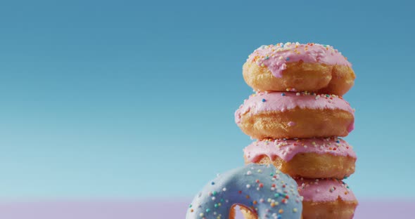 Video of donuts with icing on pink and blue background