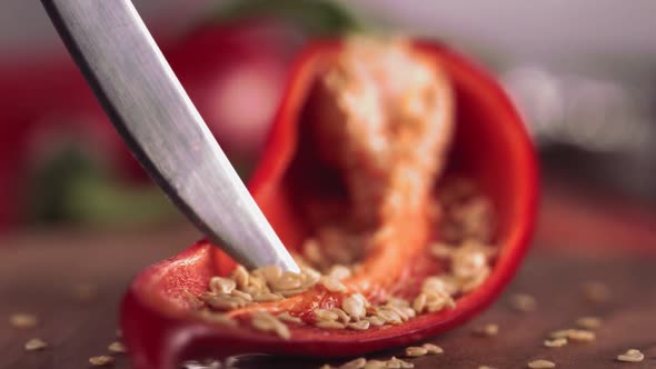 Slow Motion of Grains From Red Chilli Pepper with Knife