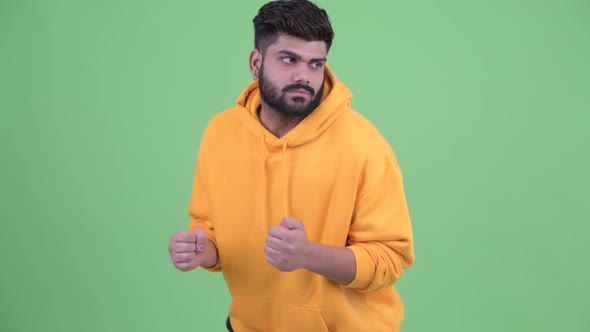 Happy Young Overweight Bearded Indian Man Dancing