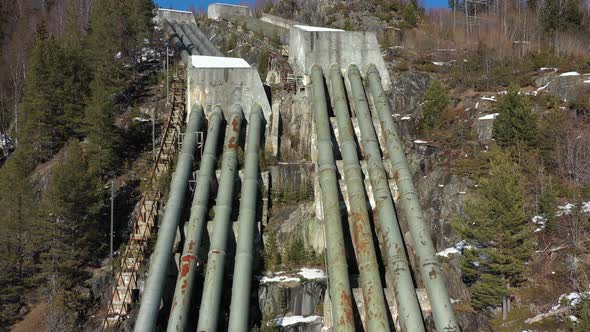 Huge pipelines leading water down hillside from Tunhovd dam into Statkraft hydroelectric powerplant