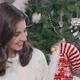 Charming Beautiful Woman Smiling to the Camera Holding Cute Santa Claus Toy - VideoHive Item for Sale