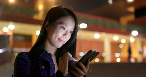 Young Woman use of mobile phone at night