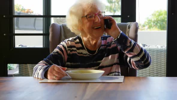 Happy senior woman talking on mobile phone 4k