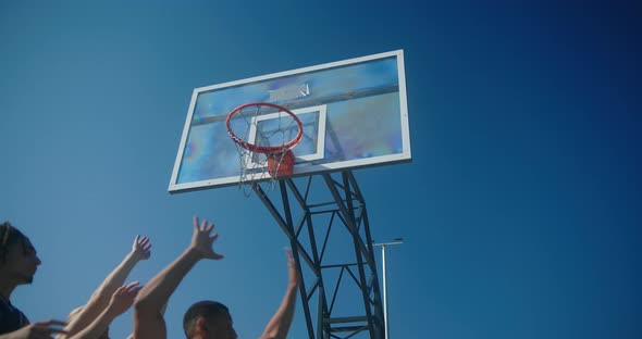 Bearded Man Wearing Blue Tshirt Scores Ball in Hoop Closeup