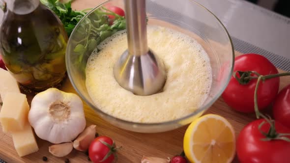Making Caesar Salad Sauce  Mixing Egg Yolk in Glass Bowl with Blender