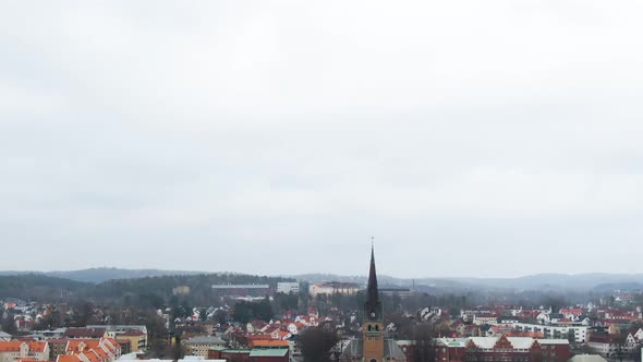 Majestic township skyline with church tower in Sweden, aerial tilt down shot