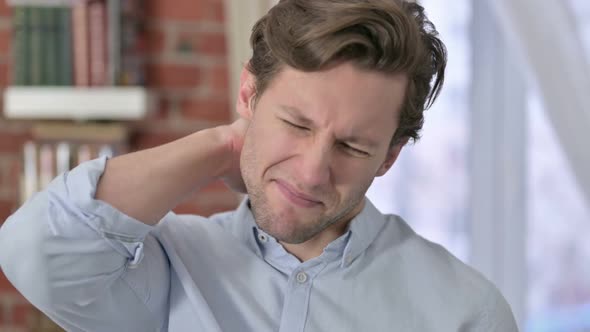 Portrait of Young Man Having Neck Pain