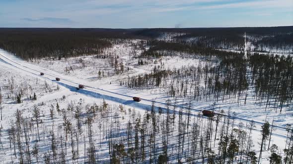 Top View of Trucks Driving on Snowy Road Is Working in Oil Industry Outdoors alt