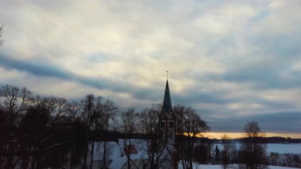 Aerial Top View of the Krimulda Evangelic Lutheran Church in Winter at Sunrise Latvia 4k Video