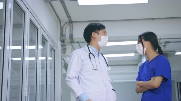 Happy Young Asian Team of Doctor and Nurse in Uniform with Stethoscope and Mask Giving High Five