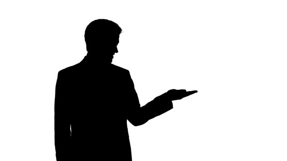 Shadow of a Caucasian man holding his hand for a copy space with white background