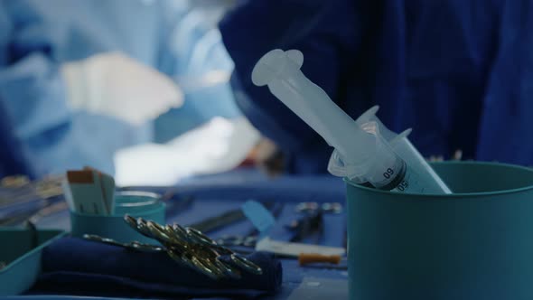 Surgeons working during open heart surgery, close up on hands and instruments.