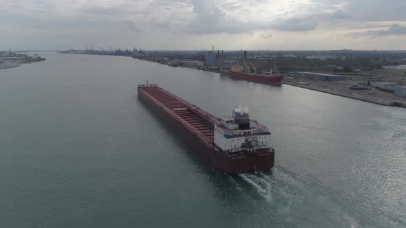 This video is of an aerial of large tanker ships in the Detroit river near downtown Detroit.