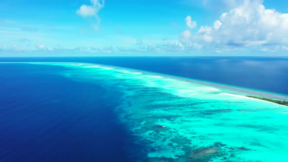 Beautiful birds eye travel shot of a paradise sunny white sand beach and blue ocean background in vi