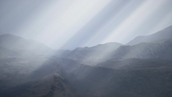 Sun Rays Against the Backdrop of the Mountains