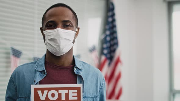 Video of black man in face mask with voting card. Shot with RED helium camera in 8K.