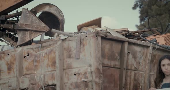 Save the planet. kids holding signs standing in a huge junkyard