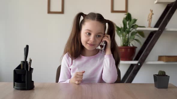 The Daughter is Talking to Her Mother on Her Cell Phone