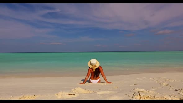 Single female happy and smiling on exotic tourist beach time by transparent ocean with white sand ba