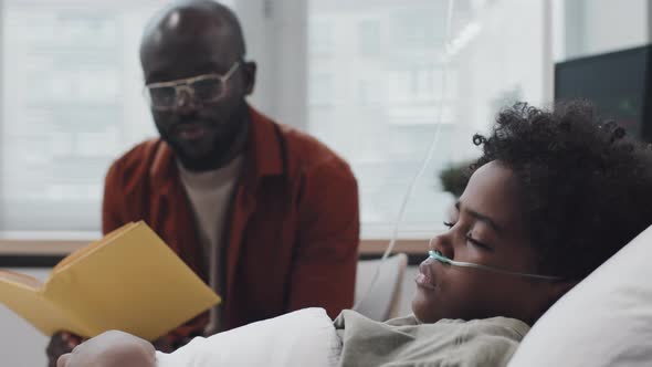 Dad Reading to Boy in Hospital