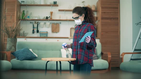 Young Lady Is Sanitizing Table Surface While Wearing a Face Mask Durong Quarantine