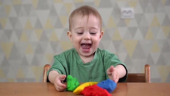 Smiling Kid Girl Having Fun with Dough, Colorful Modeling Compound Clay.