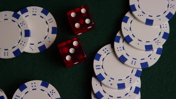 Rotating shot of poker cards and poker chips on a green felt surface - POKER 033