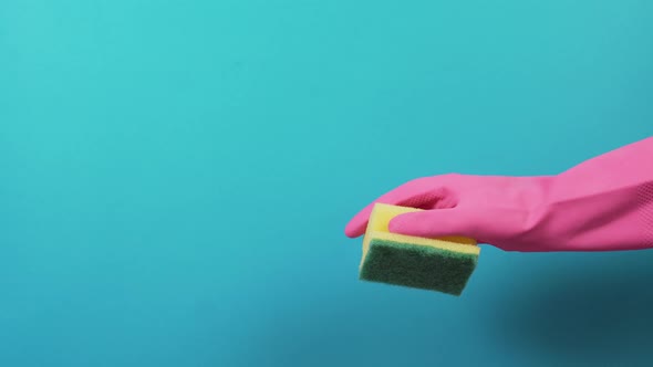 Hand in a Rubber Protective Glove with a Sponge for Washing Dishes