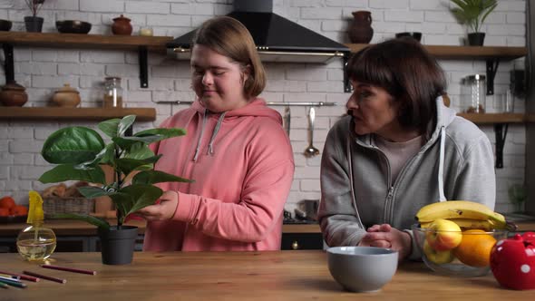 Girl with Down Syndrome Taking Care of Houseplant