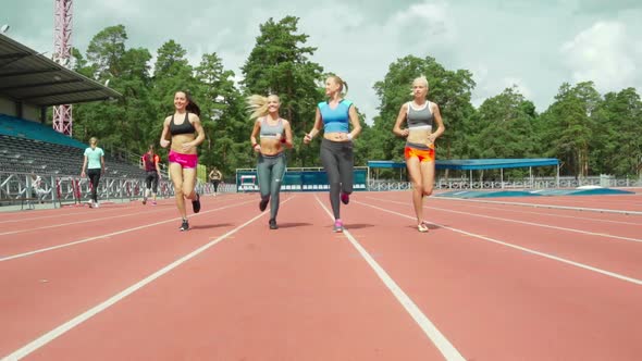 Sporty Women Jogging on Track