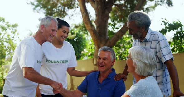 Happy volunteers shaking hands with each other 4k