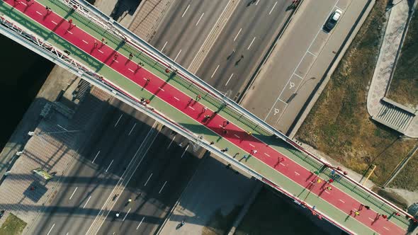 Marathon Running on the Footbridge and Road. Top View Spin Shot