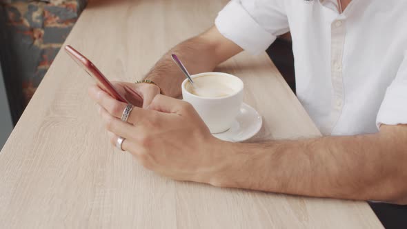 Hands of Man Using Smartphone