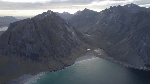 Aerial view overlooking the Vestervika beach, cloudy autumn day in Lofoten, Norway - tracking, drone