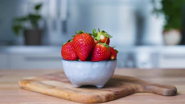 Appetizing Strawberries In A Small Bowl On A Wooden Board. close up