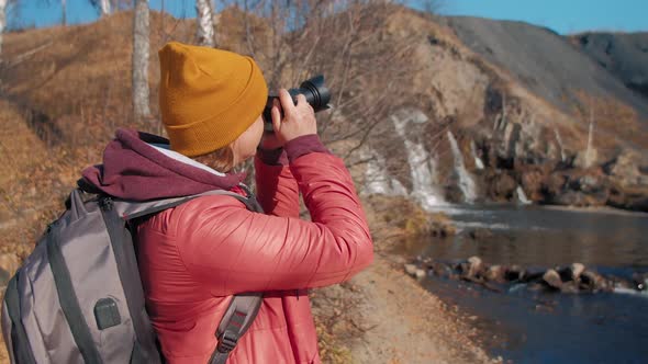 Woman Shoots Autumn Landscape with River