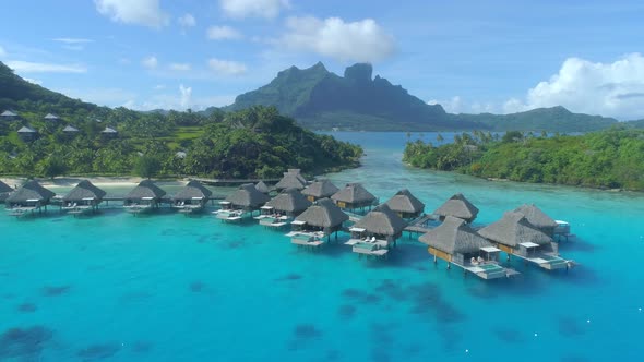 Aerial drone view of a luxury resort and overwater bungalows in Bora Bora tropical island