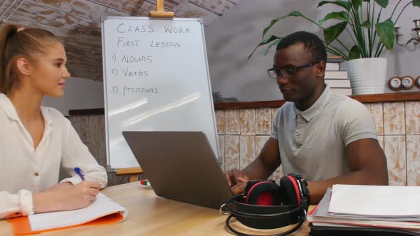 English Class - a Woman and African-american Man Having a Lesson - a Man Sitting By the Laptop and