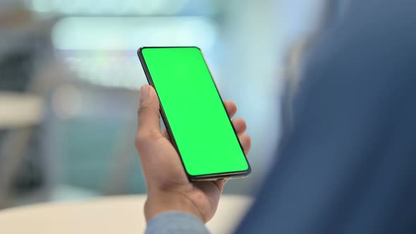 African Man Watching Video on Smartphone with Chroma Screen