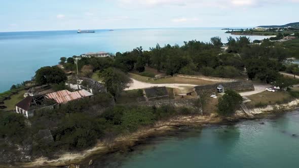 Aerial camera shot of the coast with ruins of Fort James at Saint John's, Antigua and Barbuda