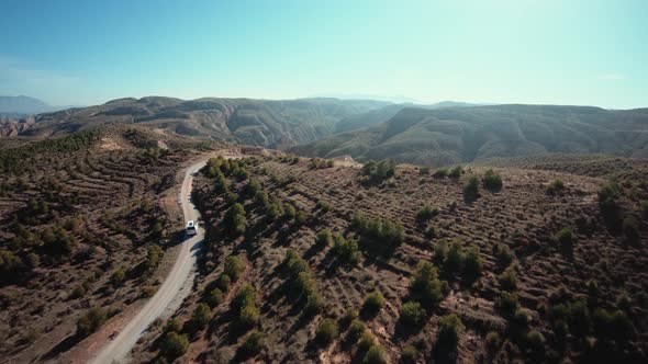 Aerial Shot of Camping Van on Gravel Mountain Road