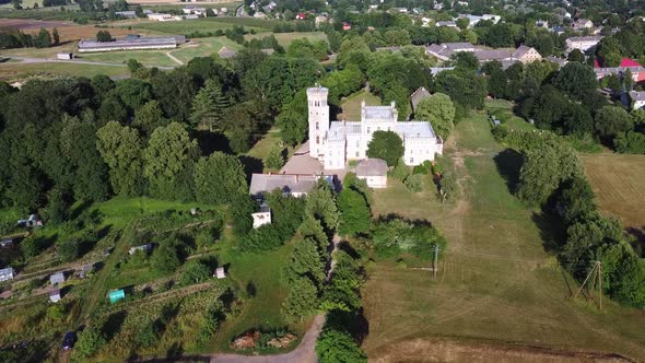 Vecauce Manor in Latvia Aerial View of the Pink Castle Through the Park. Vecauce Castle Tower With a