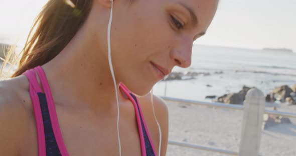 Young woman exercising by the sea