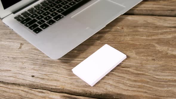 Laptop and stack of business cards