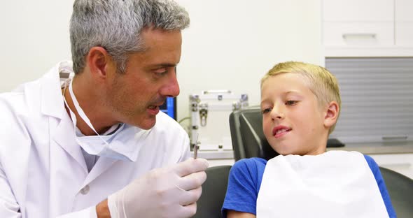 Dentist interacting with young patient