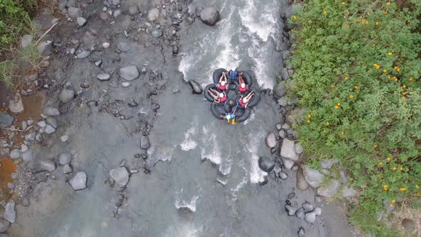 People having fun doing tubing in a Mindo river with safety accessories