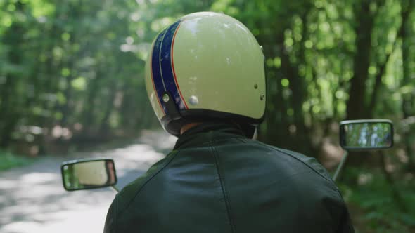 Rear view of a man with a motorcycle helmet