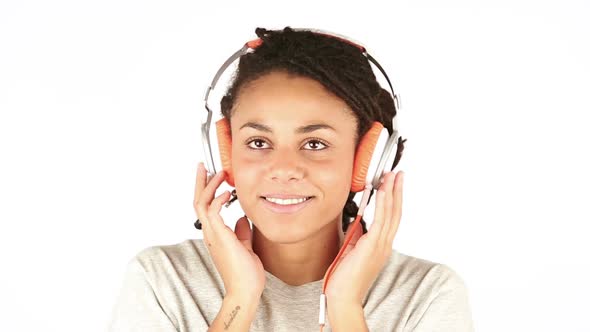 Smiling Young Woman Listening Music with Headphones